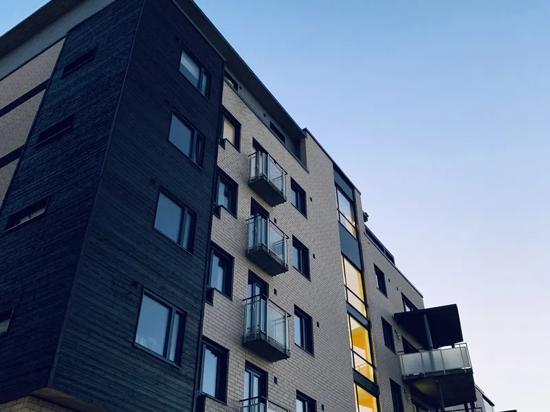 Exterior apartment building facade showing clean outdoor balcony ledges