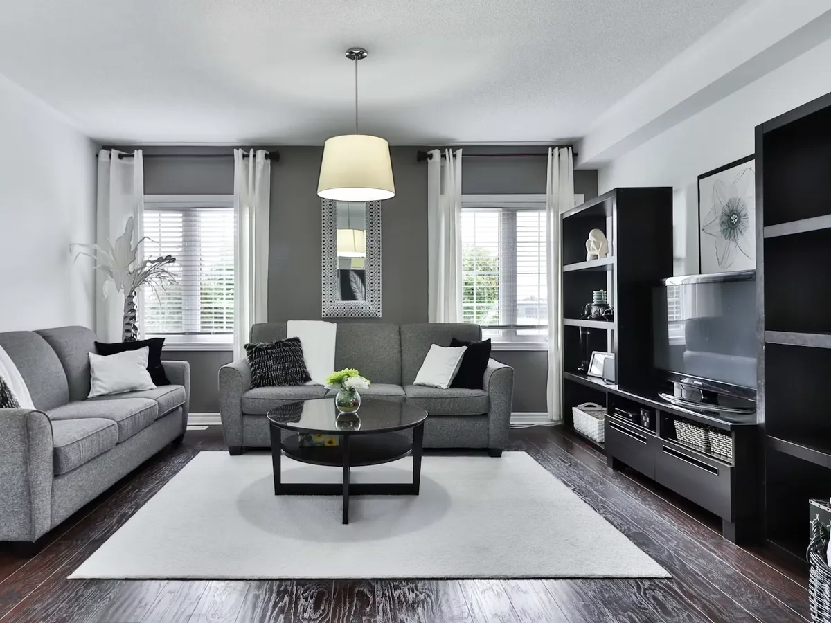 Clean modern living room with patterned area rug on floor